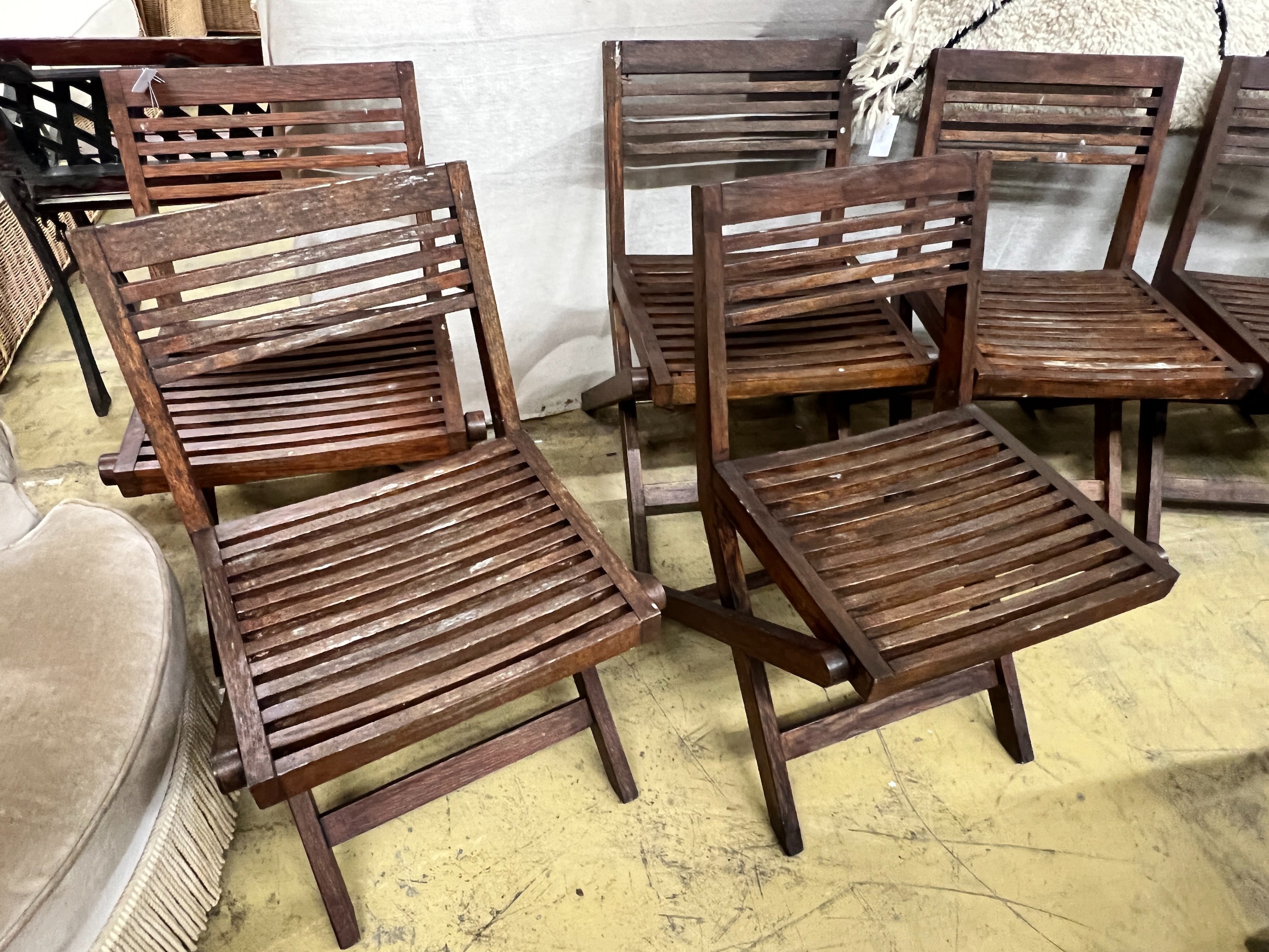 A set of six slatted teak garden chairs